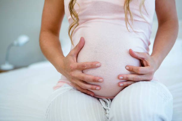 istock pregnant woman holding her bump 851810426