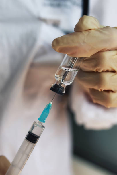 istock nurse hands holding syringe and ampoule 851810840