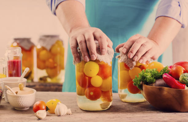 istock men with jar of pickled tomatoes 851810862