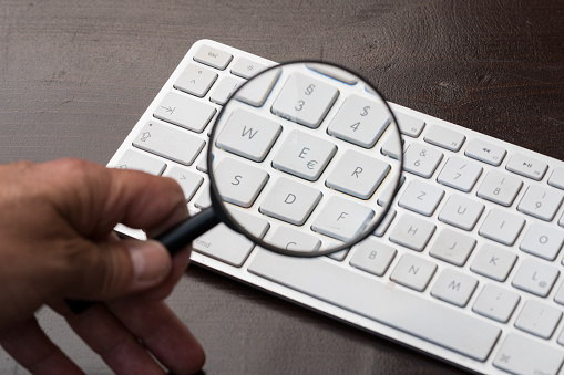 Laptop keyboard through a magnifying glass