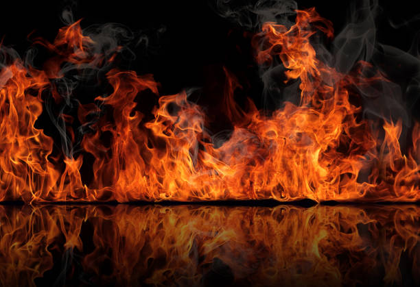 The texture of fire on a black background is reflected in a glossy table. The texture of fire on a black background is reflected in a glossy table. hell photos stock pictures, royalty-free photos & images