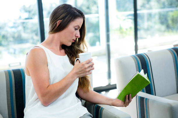 istock woman drinking coffee and reading a book 851824288