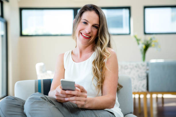 istock smiling woman on her mobile phone 851825260