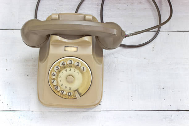 istock Old telephone on white wooden background 851828770