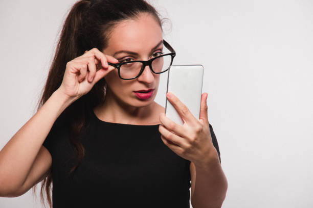 istock young woman wearing eyeglasses and using a phone 851830538