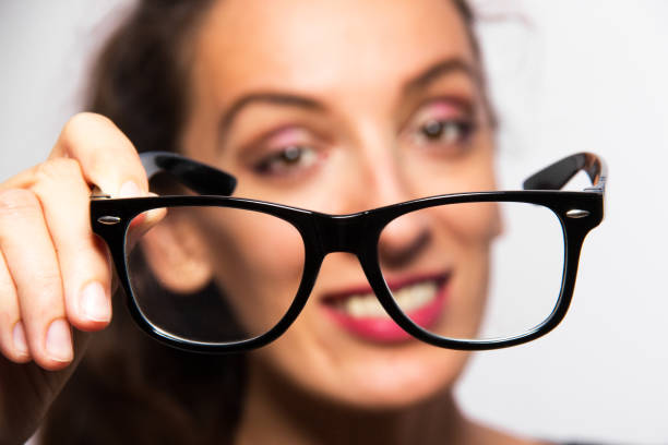 istock young woman showing eyeglasses 851832646
