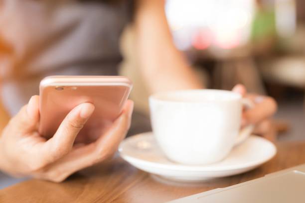 istock Woman is working She drinks coffee. She uses the phone to communicate.. Concept working women, technology, business cafe. 851832864