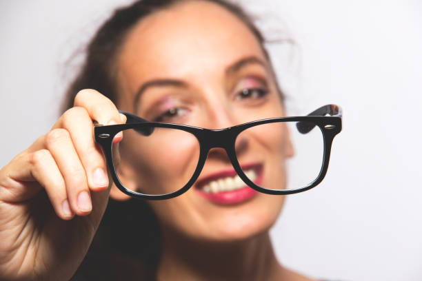 istock young woman showing eyeglasses 851833560