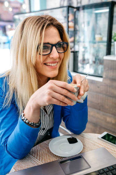 istock Woman drinking coffee and using the laptop 851833910