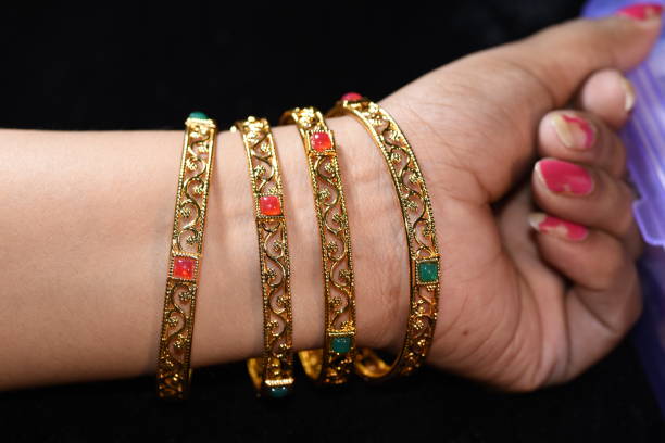 istock Fancy gold looking imitation bangles / bracelets on the woman's wrist 851843104