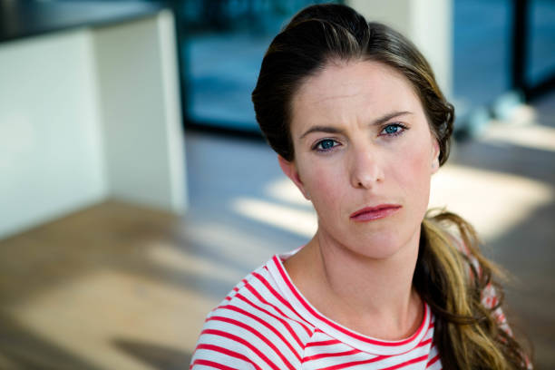istock woman staring into the camera unhappily 851843164