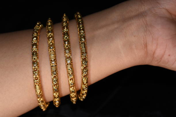 istock Fancy gold looking imitation bangles / bracelets on the woman's wrist 851847192