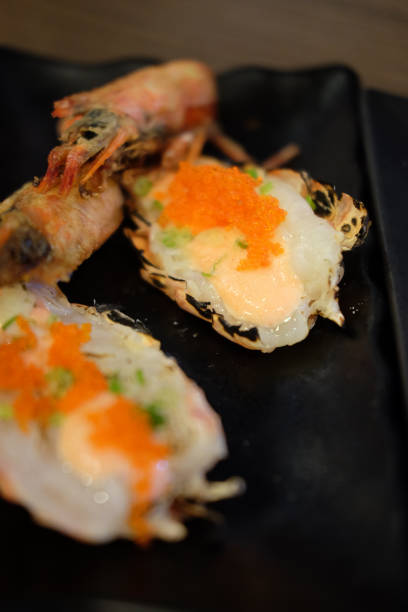 istock Fresh shrimps topping with shrimp egg on black plate 851850450