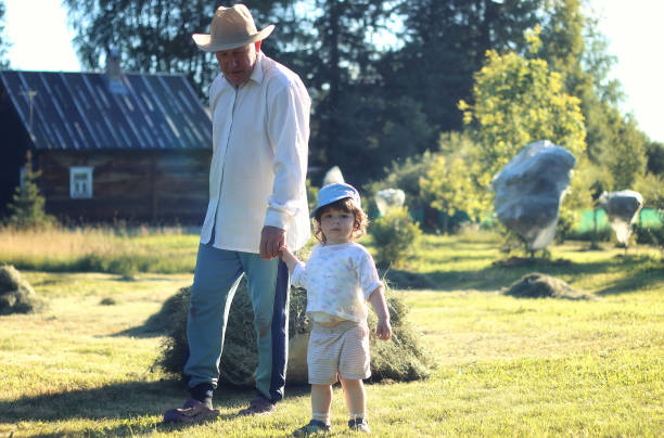 istock child and grandfather rural field 851850962