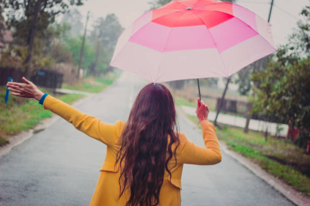 istock Beautiful young woman enjoying a rainy day 851851036
