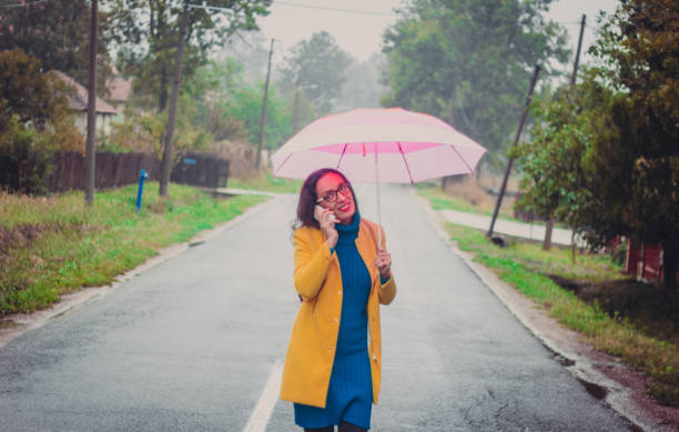 istock Beautiful young woman enjoying a rainy day 851851724