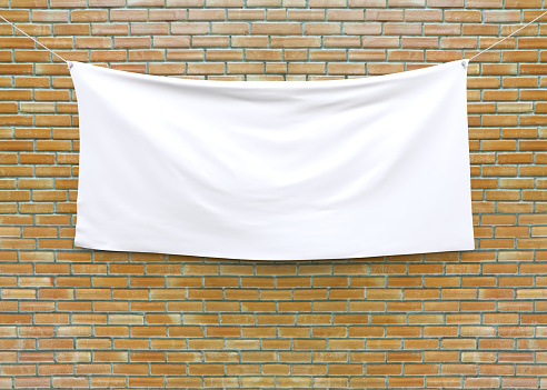 Bandera de tela colgado en pared de ladrillo. photo