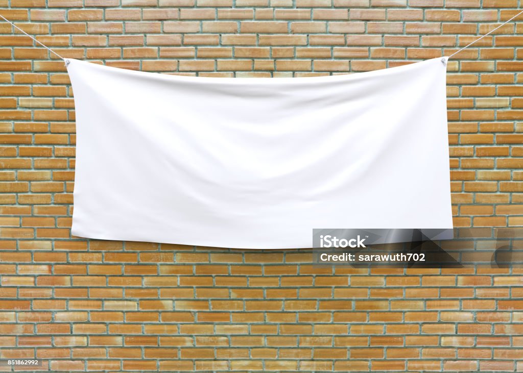 Cloth banner hanging on brick wall. Cloth banner hanging on brick wall. 3D illustration Banner - Sign Stock Photo