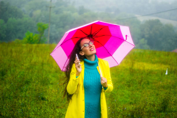 istock Woman under colorful umbrella in a park 851864208