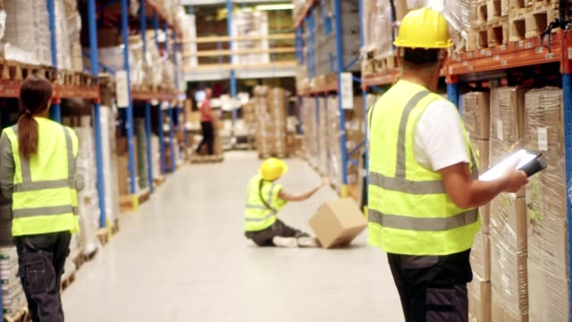 Female worker falling down in warehouse