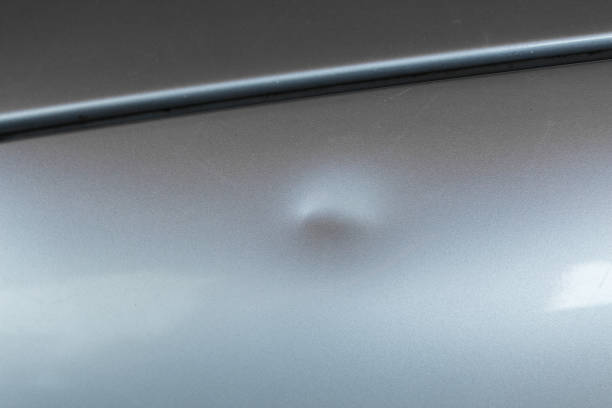 Bump on car with silver paint stock photo