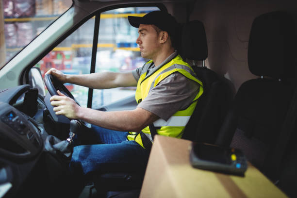 istock Delivery driver driving van with parcels on seat 851868816