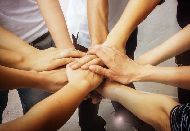 istock Close up the human hands stacked together,teamwork power,in abstract art design,blurry light background 851870414