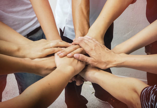 istock Close up the human hands stacked together,teamwork power,in abstract art design,blurry light background 851870418