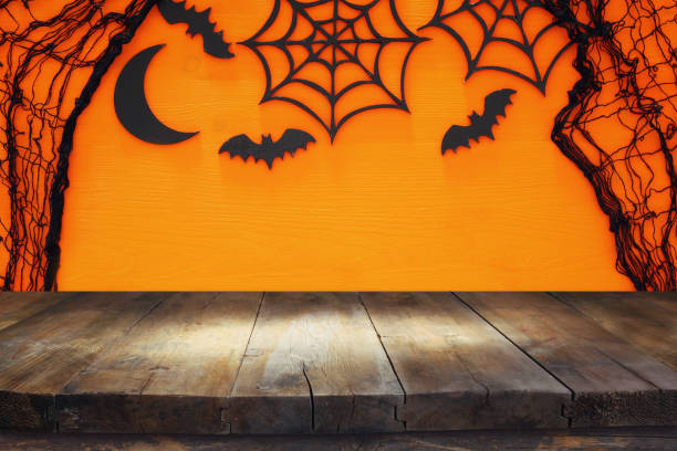 istock Halloween holiday concept with empty rustic table over orange background. Ready for product display montage 851870940
