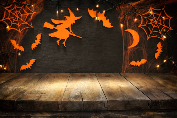 Empty rustic table in front of Halloween holiday background. Ready for product display montage