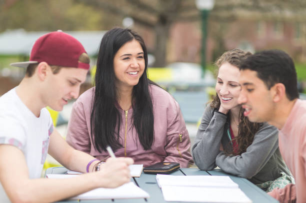 istock Multiethnic group of college students study outside at table together 851871870