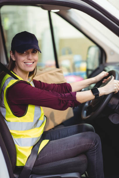 istock Delivery driver driving van with parcels on seat 851871872