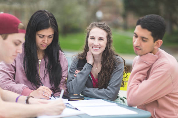 istock Multiethnic group of college students study outside at table together 851871902