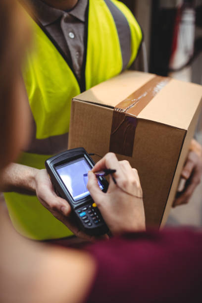 istock Woman signing on device to delivery parcel 851872872