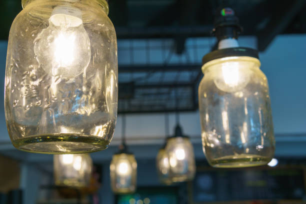 istock electricity light bulb glowing in the transparent vase hanging on the ceiling for abstract background or special occasion background. 851873666