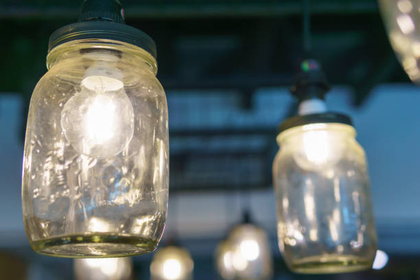 istock electricity light bulb glowing in the transparent vase hanging on the ceiling for abstract background or special occasion background. 851873688