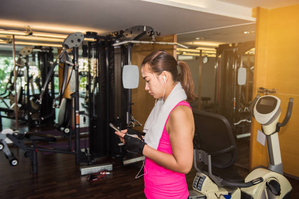 istock Active girl using smartphone in fitness gym 851874216