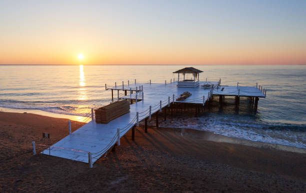 istock Wooden pier on a fancy orange sunset. 851874372