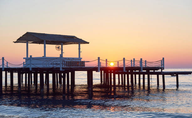 istock Wooden pier on a fancy orange sunset. 851874458
