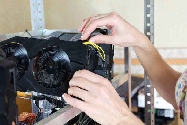 istock Women's hands touch and correct the video card for the crypto currency. Bitcoin cloud mining 851875128