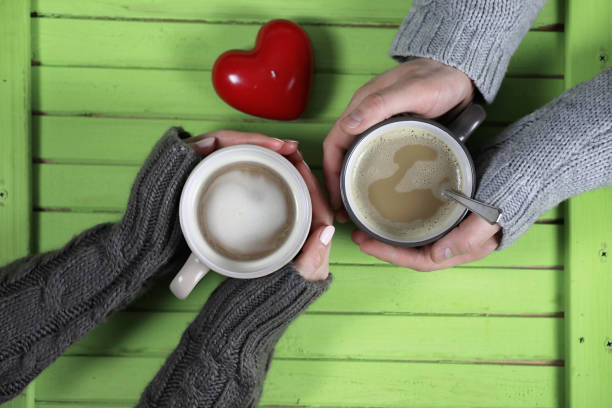istock Young couple drinking hot coffee at wooden table on a date 851878230