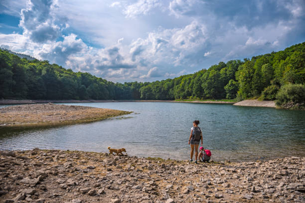 istock Mother and daughter resting by the lake 851878888