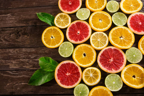 istock slices of oranges, limes, grapefruit and lemons. Over wood table background with copy space 851882504