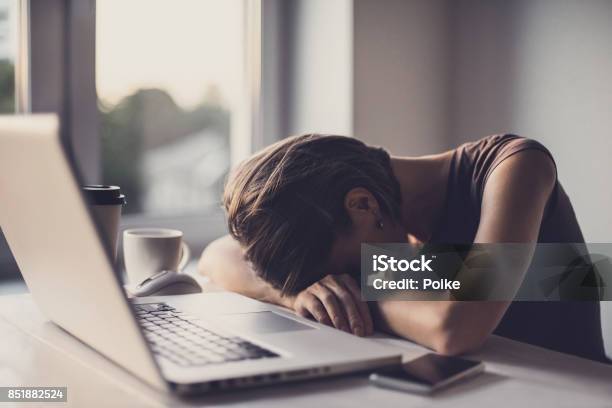 Tired Businesswoman In The Office With Laptop And Coffee Stock Photo - Download Image Now