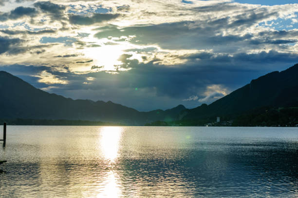 istock calm lake on a cloudy day surrounded by mountains in Alps 851885994