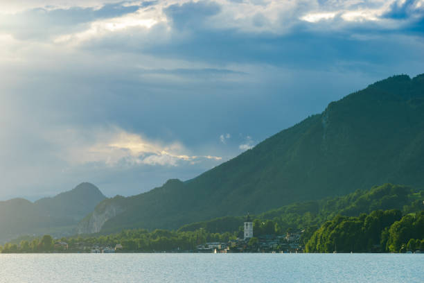 istock calm lake on a cloudy day surrounded by mountains in Alps 851886156