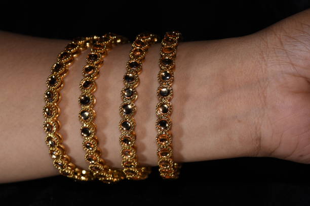 istock Fancy gold looking imitation bangles / bracelets on the woman's wrist 851887058
