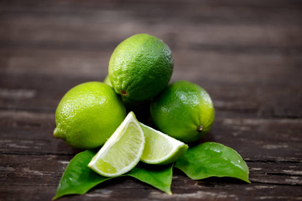 lime juice with lime slices on wooden table lime juice with lime slices on wooden table. Detox diet former yugoslavia stock pictures, royalty-free photos & images