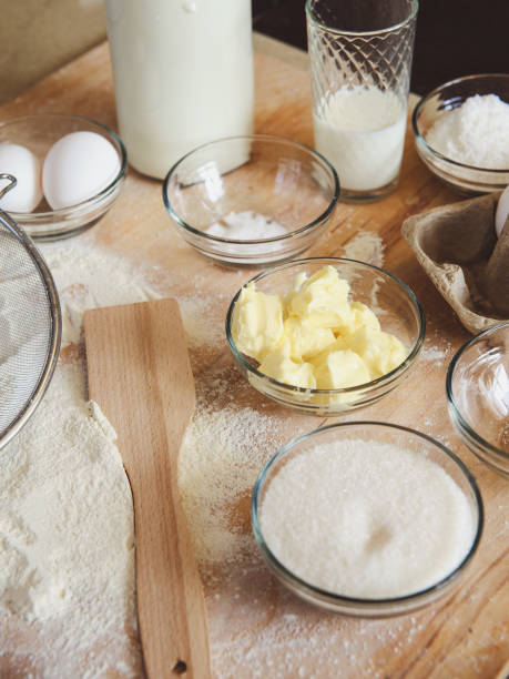 istock Baking ingredients on kitchen table. White products prepare for cooking on wooden cutting board. Lifestile food concept. 851887836