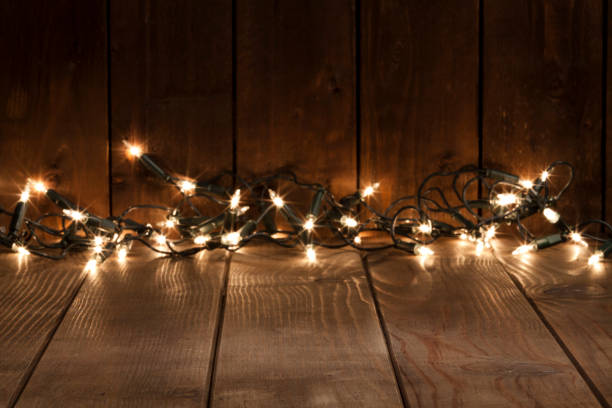 istock Empty rustic wooden table with blurred Christmas lights at background 851887918